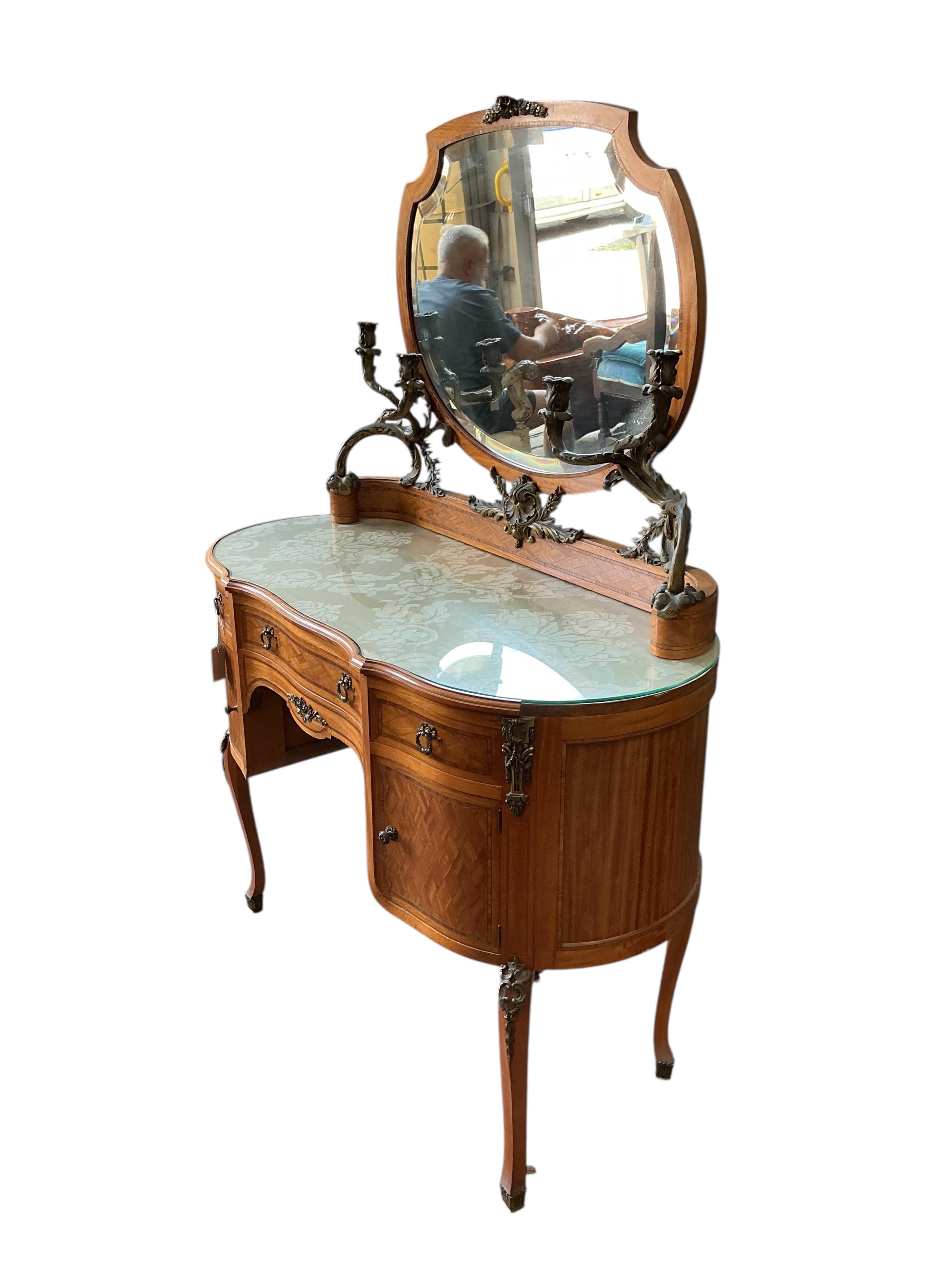 An early 20th century French transitional style gilt metal mounted tulip banded and parquetry inlaid kneehole dressing table, width 115cm, depth 50cm, height 160cm